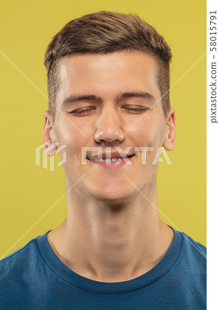 Caucasian young man's close up shot on yellow background Caucasian young man's close up shot on yellow background 58015791