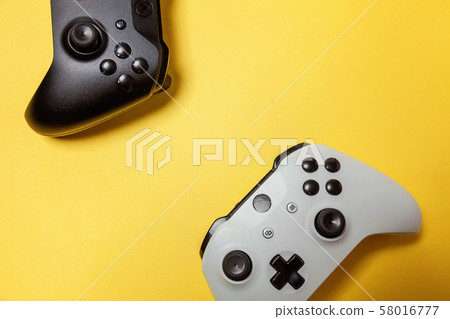 White and black two joystick on yellow background. White and black two joystick on yellow background. 58016777