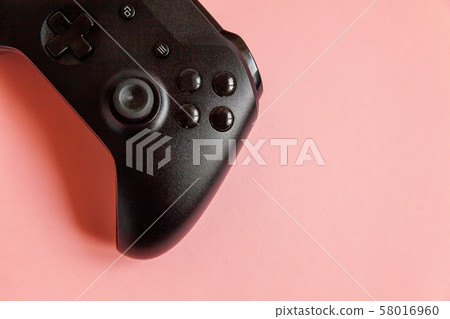 Black joystick on pink background. Computer gaming Black joystick on pink background. Computer gaming 58016960