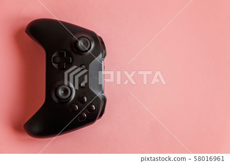 Black joystick on pink background. Computer gaming Black joystick on pink background. Computer gaming 58016961