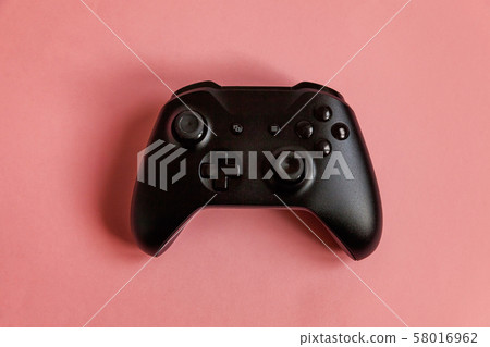 Black joystick on pink background. Computer gaming Black joystick on pink background. Computer gaming 58016962