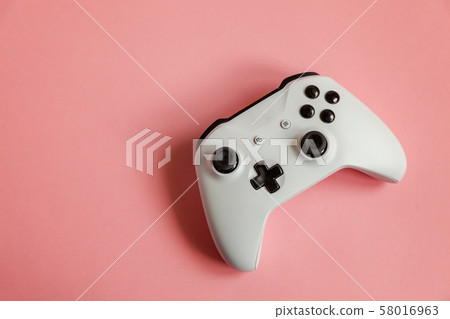White joystick on pink background. Computer gaming White joystick on pink background. Computer gaming 58016963