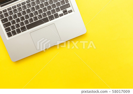 Keyboard laptop computer isolated on yellow desk 58017009