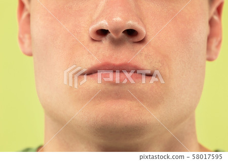 Caucasian young man's close up shot on green background 58017595