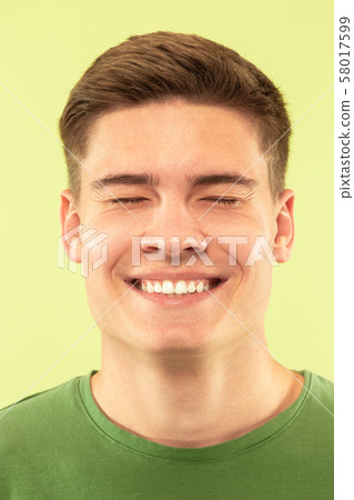 Caucasian young man's close up shot on green background 58017599