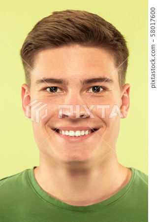Caucasian young man's close up shot on green background 58017600