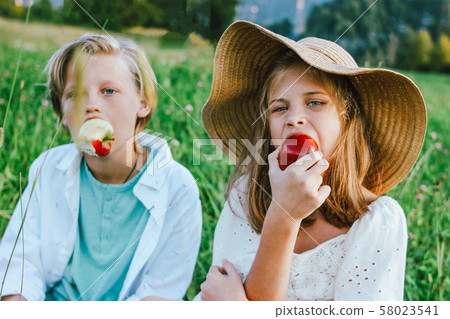 Funny children with apples brother and sister Funny children with apples brother and sister 58023541
