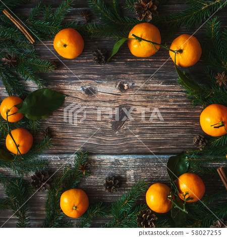 Christmas background with tangerines and fir branches, pine cones 58027255