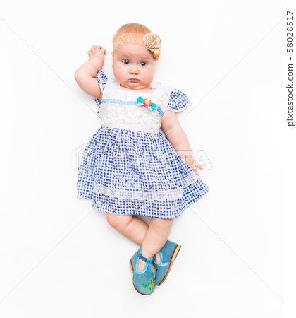 Portrait of a sweet infant baby girl wearing dress and headband bow, isolated on white in studio Portrait of a sweet infant baby girl wearing dress and headband bow, isolated on white in studio 58028517