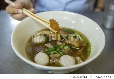 Eating clear stewed beef soup in Thailand, focus Eating clear stewed beef soup in Thailand, focus 58028563