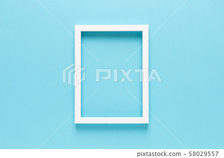 Empty photo frame on blue background 58029557