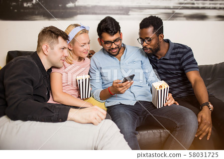 Friends using smartphone at home 58031725