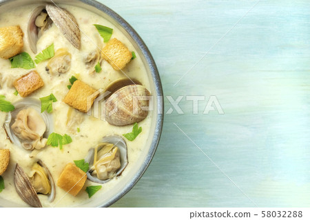 Clam chowder with fresh parsley and croutons, close-up shot from the top with a place for text Clam chowder with fresh parsley and croutons, close-up shot from the top with a place for text 58032288