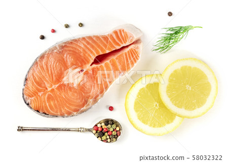 Salmon steak, shot from the top on a white background with lemon, dill, and pepper 58032322