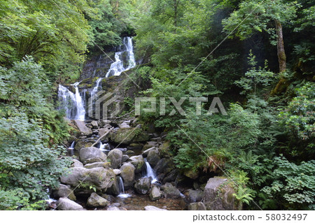 Small mountain waterfall on the rocks covered with moss in the forest Small mountain waterfall on the rocks covered with moss in the forest 58032497