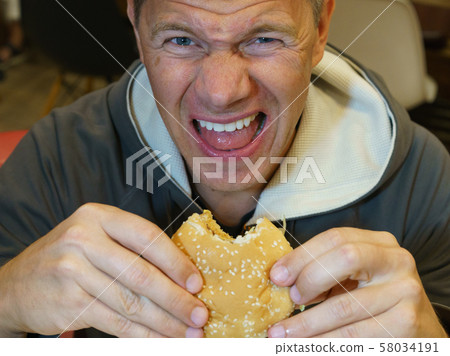 Fast food eating 58034191