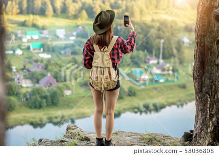 young ambitious girl taking photo, trying to catch wonderful moment young ambitious girl taking photo, trying to catch wonderful moment 58036808