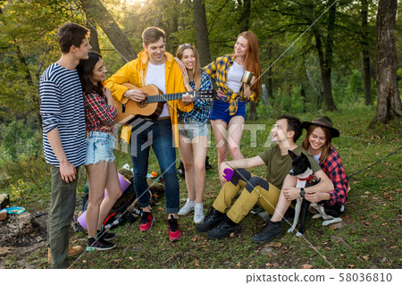 young positive tourists celebrating their successful travel young positive tourists celebrating their successful travel 58036810