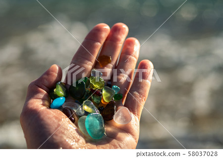 Colorful pieces of sea glass in a hand 58037028