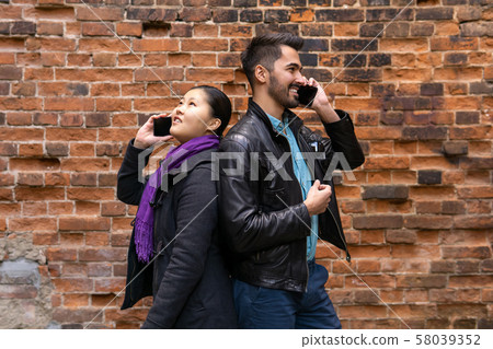 young man and woman stand nearby back to back, young man and woman stand nearby back to back, 58039352