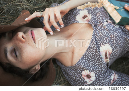 girl lies in dry grass 58039597