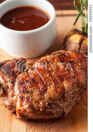 Grilled pork steak with ketchup, garlic, rosemary Grilled pork steak with ketchup, garlic, rosemary 58039921