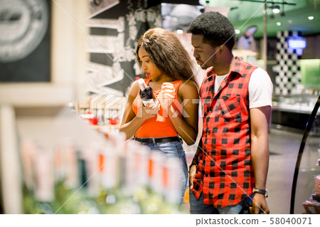 family shopping in a supermarket. African couple in supermarket 58040071