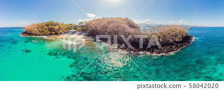 Couple snorkeling in the blue sea ocean and coral background aerial top view Couple snorkeling in the blue sea ocean and coral background aerial top view 58042020