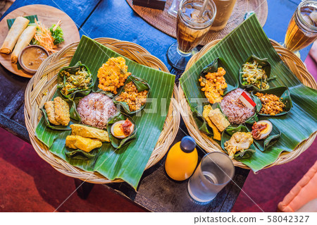 Nasi lemak, Nasi campur, Indonesian Balinese rice with potato fritter, sate lilit, fried tofu, spicy 58042327
