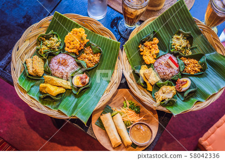 Nasi lemak, Nasi campur, Indonesian Balinese rice with potato fritter, sate lilit, fried tofu, spicy Nasi lemak, Nasi campur, Indonesian Balinese rice with potato fritter, sate lilit, fried tofu, spicy 58042336
