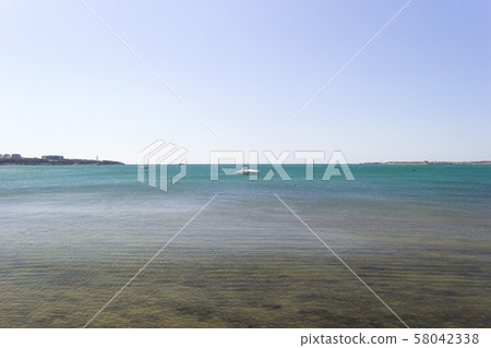 Scenic view on seascape from sea bay. Boats and ships in the distance. Skyline, coast and clear sky Scenic view on seascape from sea bay. Boats and ships in the distance. Skyline, coast and clear sky 58042338