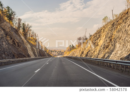 Amazing view with colorful autumn forest with asphalt mountain road. Beautiful landscape with empty Amazing view with colorful autumn forest with asphalt mountain road. Beautiful landscape with empty 58042578
