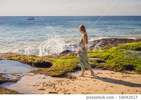 Young woman tourist on Pantai Tegal Wangi Beach, Bali Island, Indonesia. Bali Travel Concept 58042617