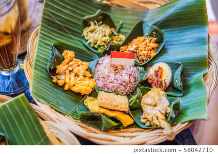 Nasi lemak, Nasi campur, Indonesian Balinese rice with potato fritter, sate lilit, fried tofu, spicy 58042710