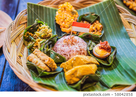 Nasi lemak, Nasi campur, Indonesian Balinese rice with potato fritter, sate lilit, fried tofu, spicy 58042858