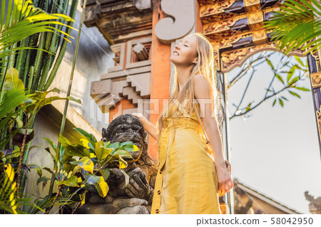 Young woman tourist on the background of Balinese doors. Bali Travel Concept 58042950