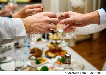 hands with glasses at shallow depth of field hands with glasses at shallow depth of field 58043043