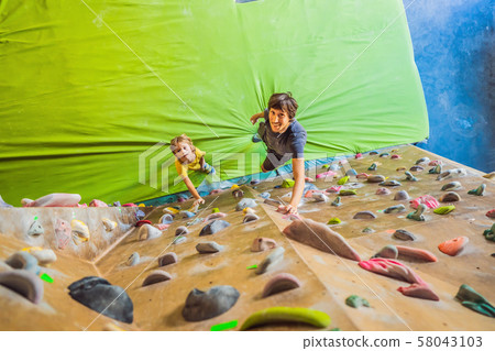 Dad and son at the climbing wall. Family sport, healthy lifestyle, happy family 58043103