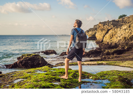 Young man tourist on Pantai Tegal Wangi Beach, Bali Island, Indonesia. Bali Travel Concept 58043185