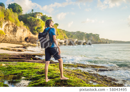 Young man tourist on Pantai Tegal Wangi Beach, Bali Island, Indonesia. Bali Travel Concept 58043495