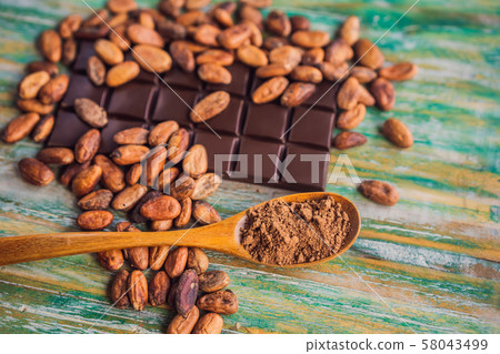 Chocolate and cocoa beans on color wooden background 58043499