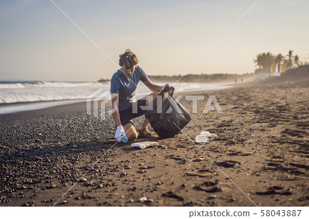 Young man cleaning up the beach. Natural education of children 58043887