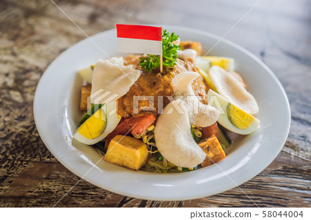Gado-gado Indonesian salad served with peanut sauce. Ingredients: tofu, spinach, string beans, soy 58044004