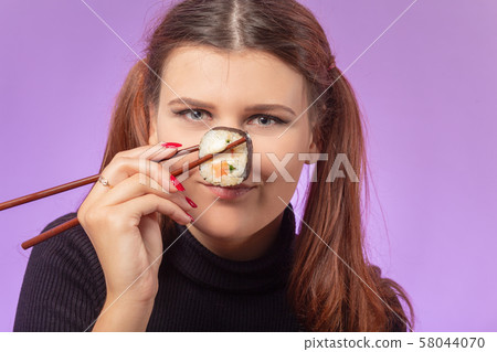 woman with sushi 58044070