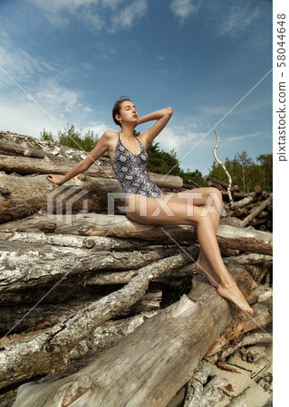 slim woman sunbathes slim woman sunbathes 58044648