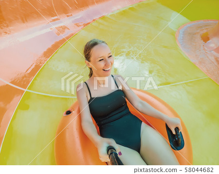 happy child have fun on water slike on outdoor swimming pool happy child have fun on water slike on outdoor swimming pool 58044682