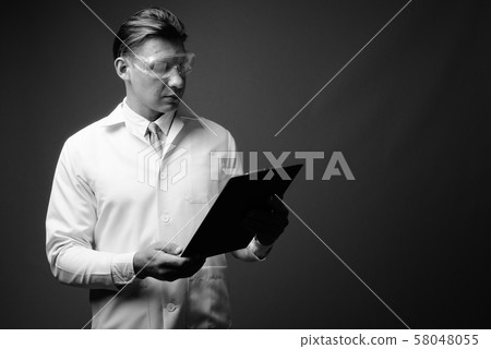 Man doctor wearing protective glasses shot in black and white 58048055