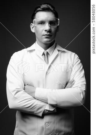 Man doctor wearing protective glasses shot in black and white Man doctor wearing protective glasses shot in black and white 58048056