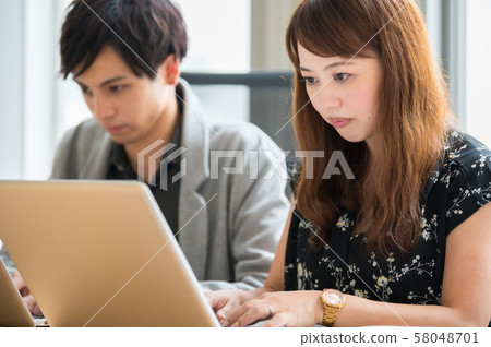 Young man and woman doing business desk work 58048701