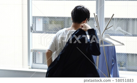 Men getting dressed ready to go out Men getting dressed ready to go out 58051883